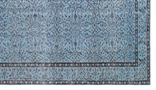 Load image 1 in gallery view. Light blue and dark brown distressed rug with a traditional floral medallion pattern and a geometric border.
