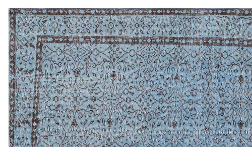 Load image 1 in gallery view. Light blue and dark brown traditional rug with a distressed floral medallion pattern and a geometric border.
