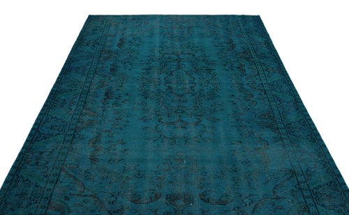 Load image 1 in gallery view. Teal vintage-style rug with a dark, distressed central medallion and ornate border pattern on a white background.