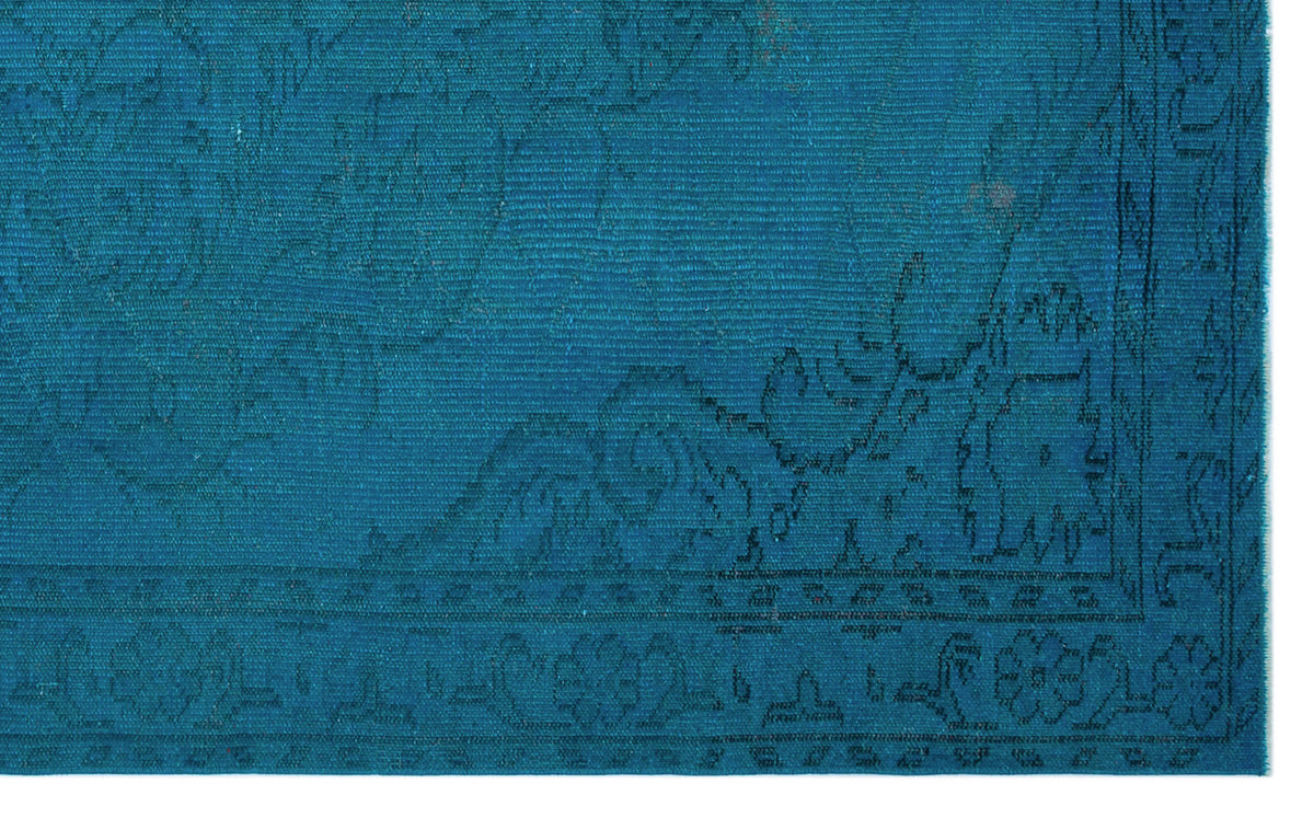 Teal rug with a dark blue traditional floral medallion pattern and a detailed border.