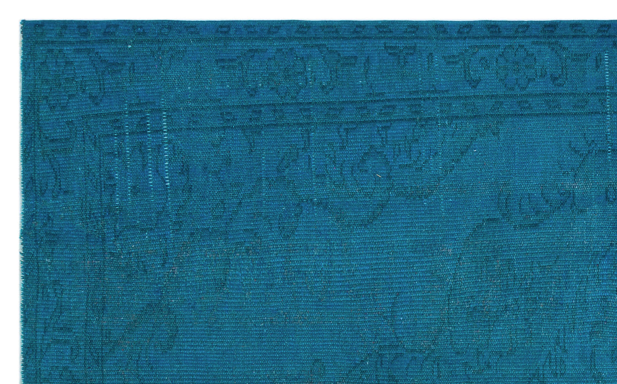 Teal monochromatic rug with a subtle, tone-on-tone traditional floral border and medallion pattern.