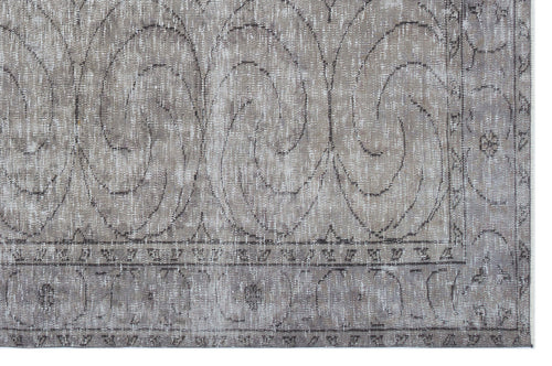 Load image 1 in gallery view. Taupe and grey distressed rug with a large-scale swirling scroll pattern and a decorative geometric border.