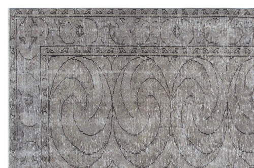 Load image 1 in gallery view. Distressed taupe and grey rug with a large-scale swirling floral medallion pattern and a decorative border.