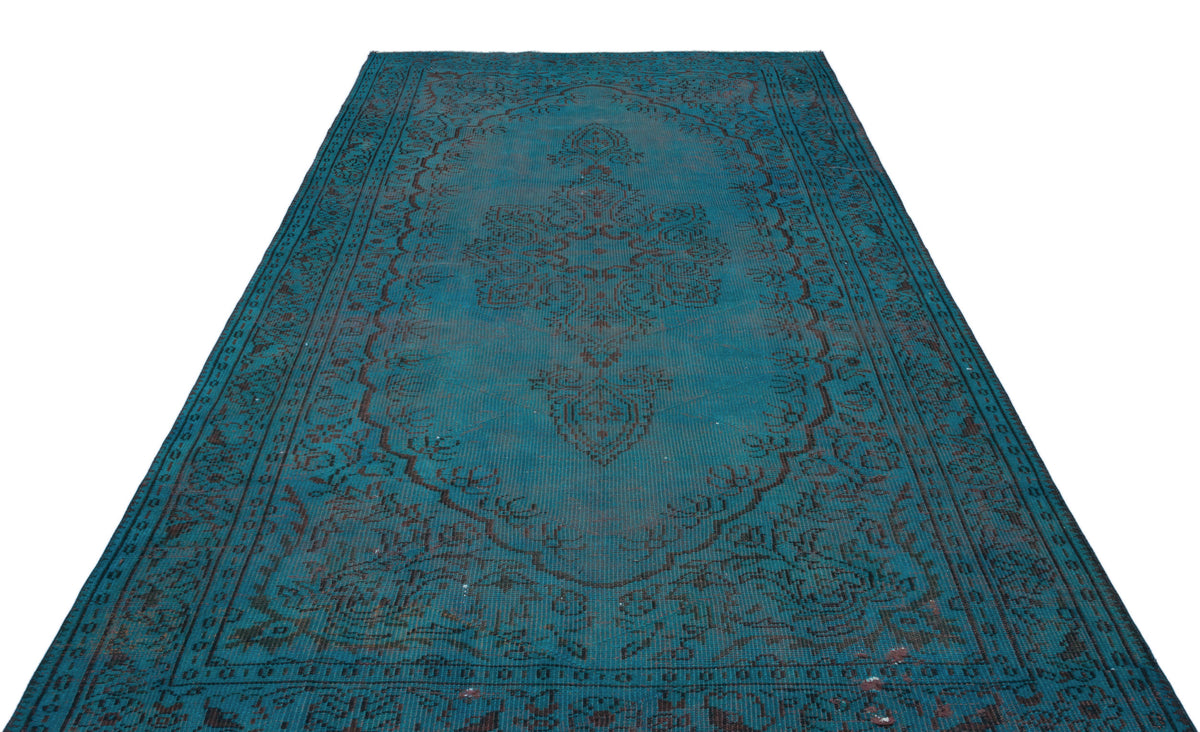 Teal and dark brown traditional rug with a central floral medallion and ornate border on a white background.