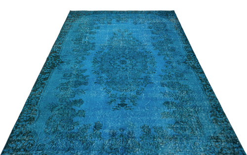 Load image 1 in gallery view. Bright blue distressed area rug with a dark central floral medallion and ornate border on a white background.