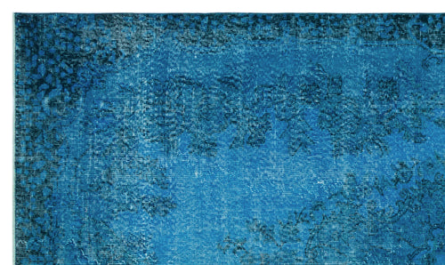 Load image 1 in gallery view. Bright blue distressed rug with a faded traditional floral medallion pattern.