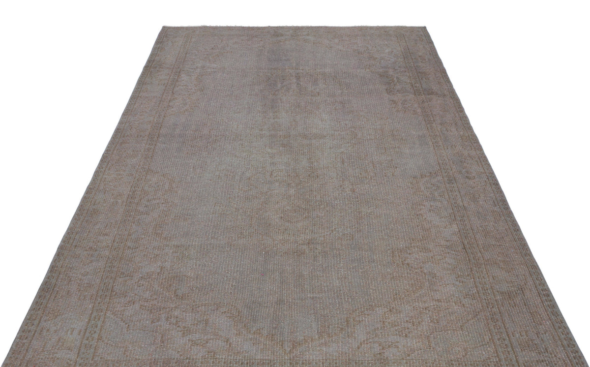 Taupe and grey vintage-style rug with a faded, distressed traditional medallion pattern on a white background.
