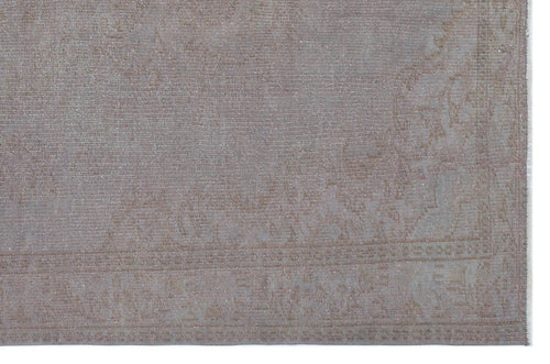 Load image 1 in gallery view. Taupe and grey distressed rug with a faint, traditional medallion border pattern on a white background.