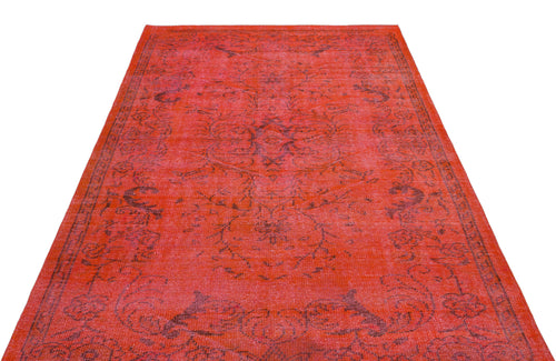 Load image 1 in gallery view. Bright red vintage-style rug with a faded black floral medallion pattern on a white background.