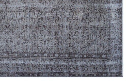Load image 1 in gallery view. Distressed charcoal and grey rug with a traditional medallion pattern and a geometric border.