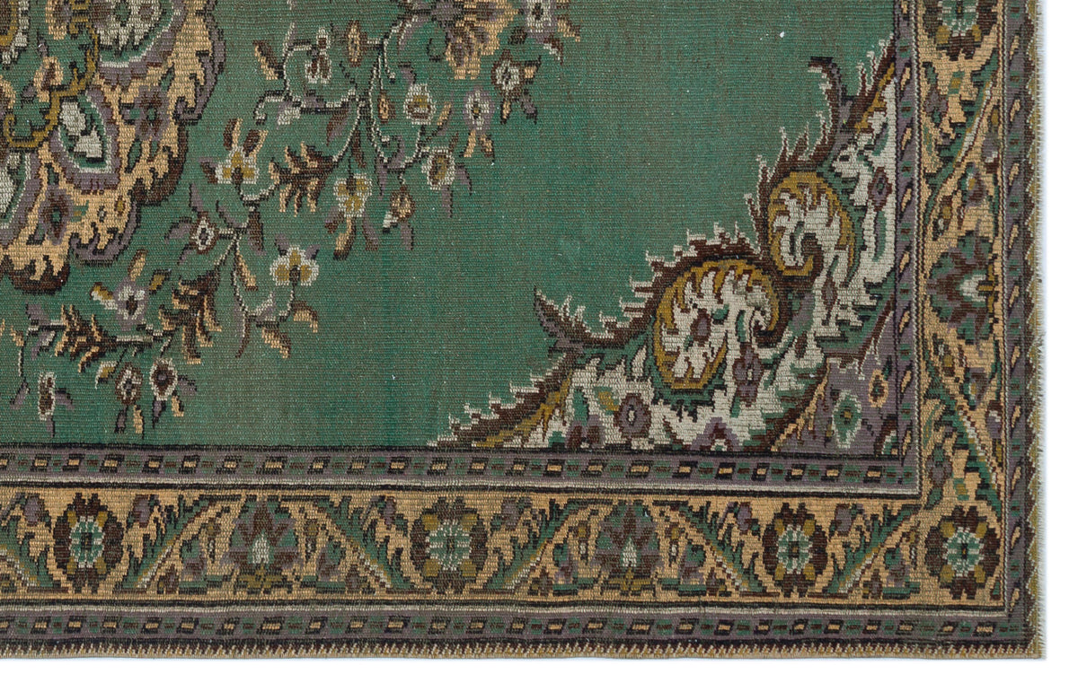 Teal rug with a traditional floral medallion pattern, intricate beige and purple detailing, and a geometric border.