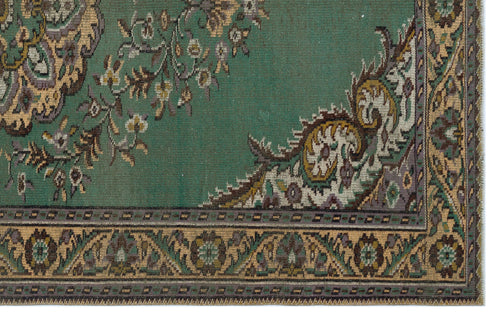 Load image 1 in gallery view. Teal rug with a traditional floral medallion pattern, intricate beige and purple detailing, and a geometric border.