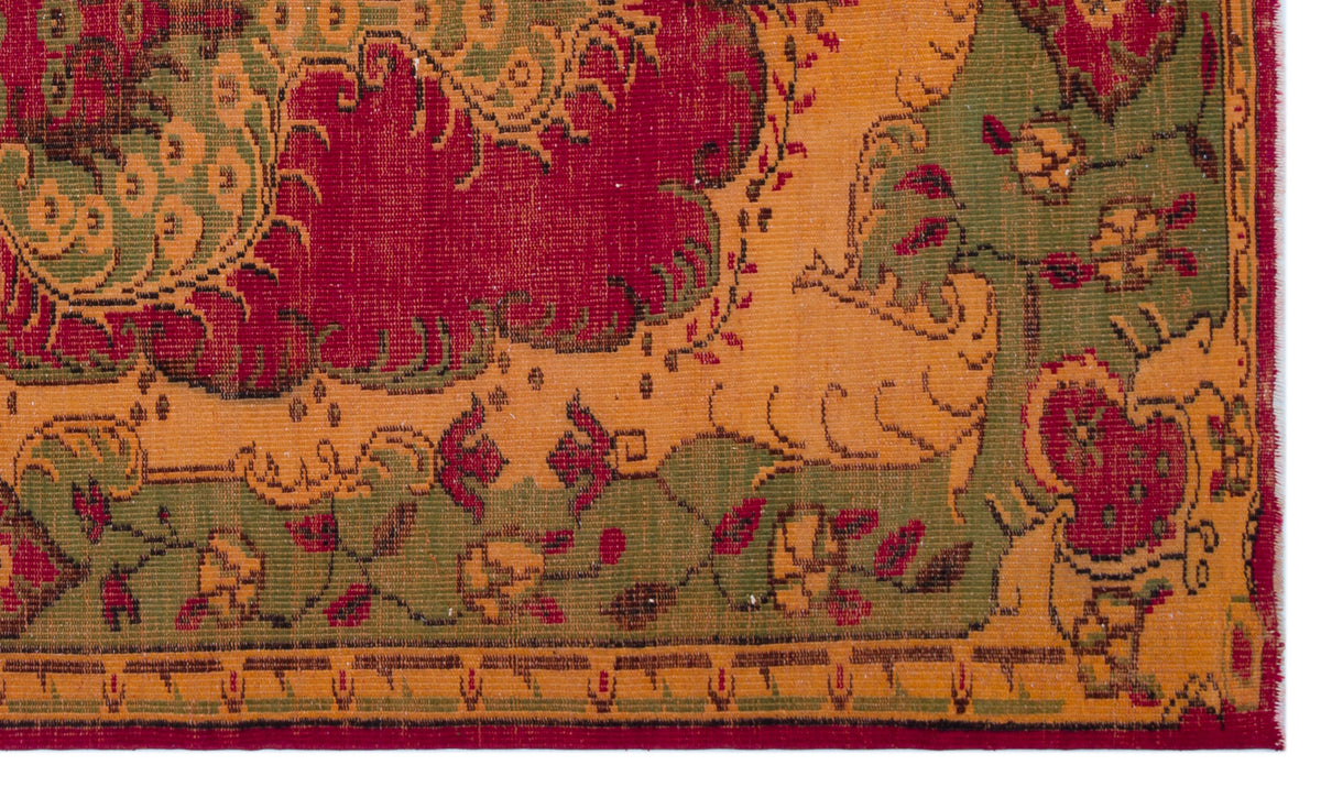 Traditional rug with a red, gold, and olive green floral medallion pattern and a geometric border.