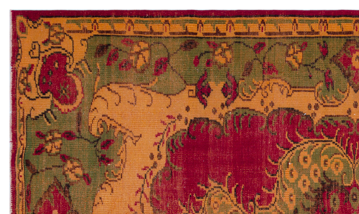 Traditional rug with a red, olive green, and gold floral medallion pattern and a geometric border.