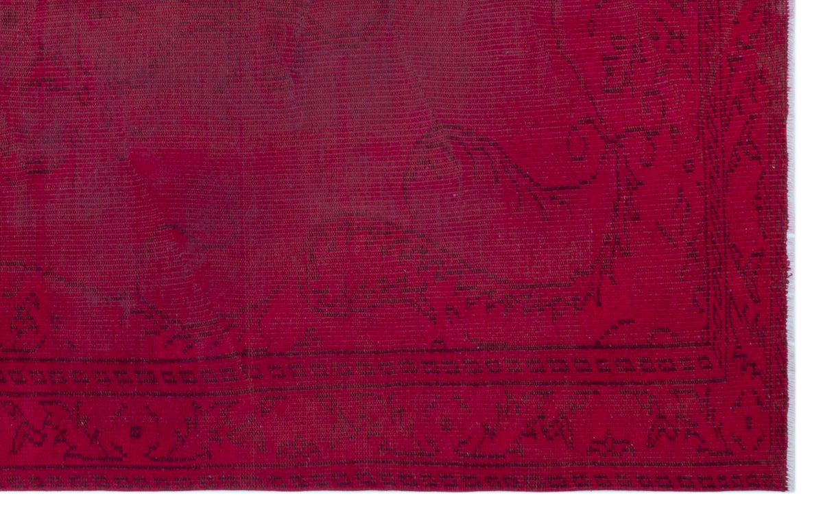 Deep red overdyed vintage rug with a subtle, dark-toned traditional floral medallion pattern and a geometric border.