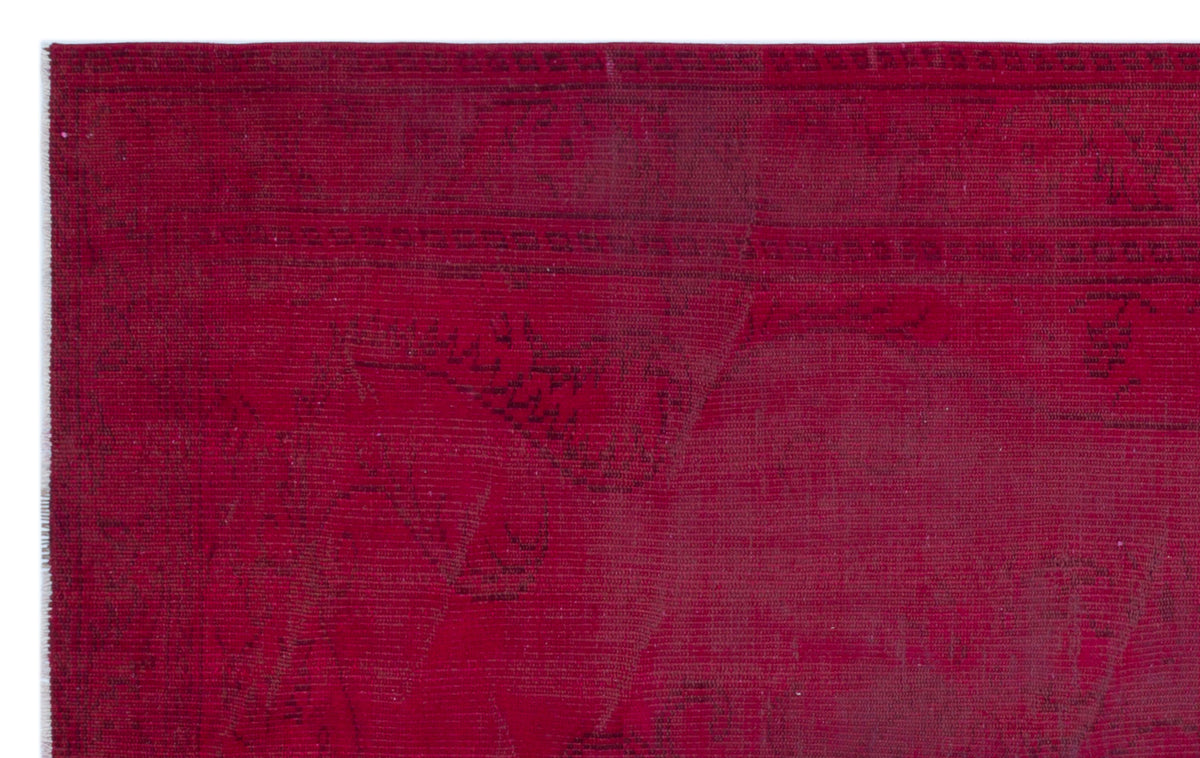 Deep red vintage-style rug with a faint, tonal traditional medallion pattern and a linear border.