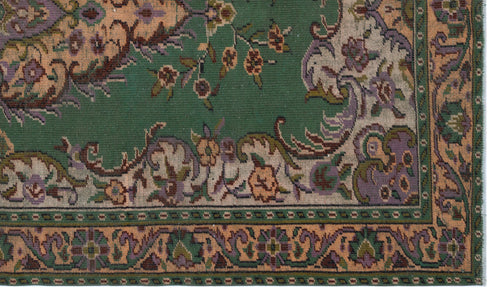 Load image 1 in gallery view. Green traditional rug with a floral medallion pattern in peach, purple, and beige, featuring a detailed border.