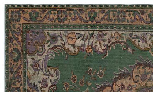 Load image 1 in gallery view. Green traditional rug with a floral border and central medallion featuring purple, orange, and cream accents.
