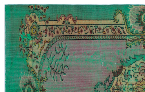 Load image 1 in gallery view. Emerald green and mauve vintage-style rug with a distressed floral border and central medallion pattern.