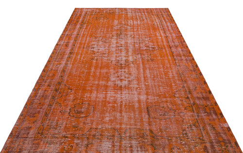 Load image 1 in gallery view. Burnt orange distressed area rug with a faded traditional medallion pattern and a bordered edge.