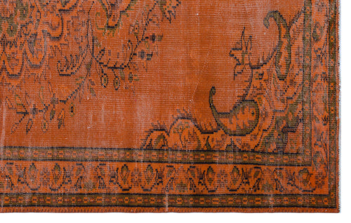 Load image 1 in gallery view. Burnt orange vintage-style rug with a distressed floral medallion pattern and a geometric border.