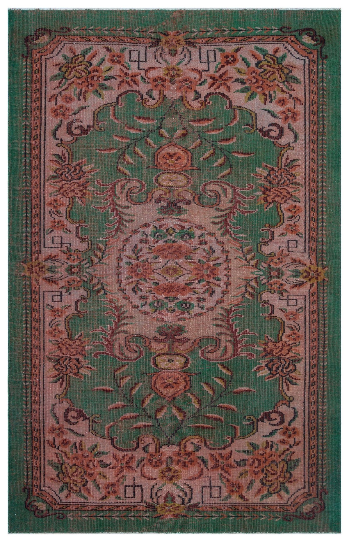Green and dusty pink vintage-style rug with a central floral medallion and intricate botanical border.