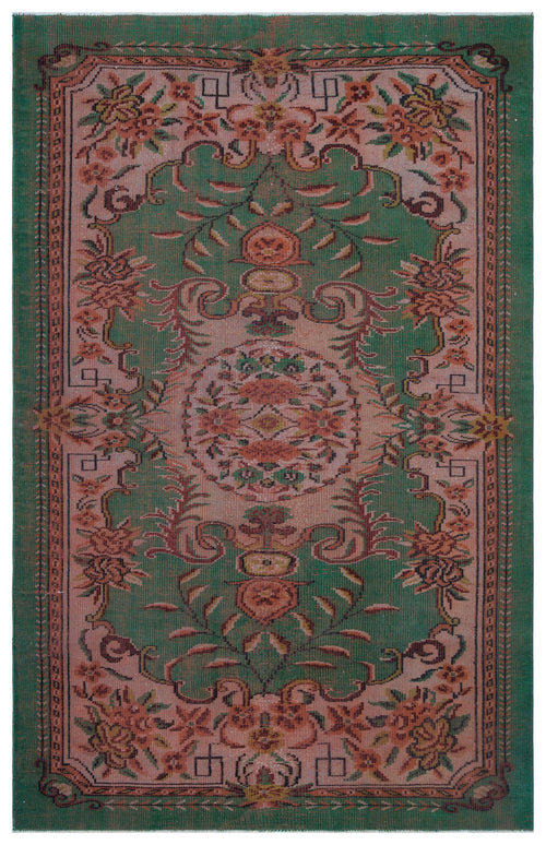 Load image 1 in gallery view. Green and dusty pink vintage-style rug with a central floral medallion and intricate botanical border.