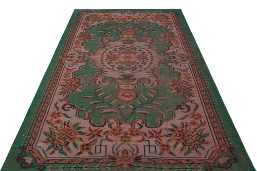Load image 1 in gallery view. Green and muted pink vintage-style rug with a central floral medallion and ornate botanical border.