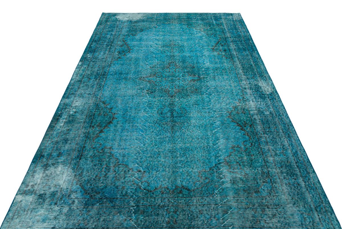Teal and black distressed vintage-style rug with a central medallion pattern on a white background.