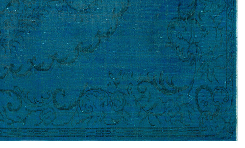 Load image 1 in gallery view. Teal rug with a distressed, dark blue floral medallion pattern and a fringed edge.