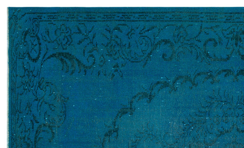 Load image 1 in gallery view. Teal rug with a dark blue distressed floral medallion pattern and a decorative border.
