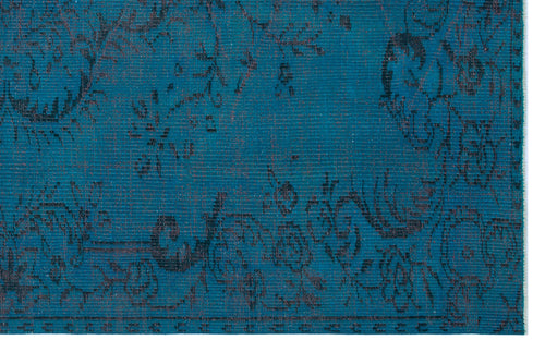 Load image 1 in gallery view. Teal rug with a dark, distressed floral pattern and a visible woven texture.