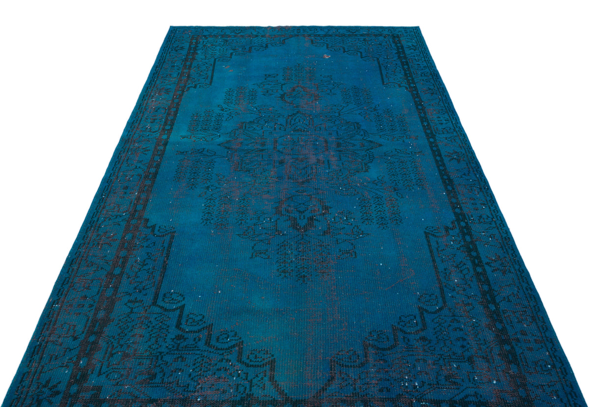 Teal vintage-style rug with a dark charcoal central medallion and ornate border on a white background.