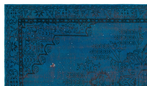 Load image 1 in gallery view. Deep blue rug with a black traditional floral border and distressed, faded pattern on a white background.