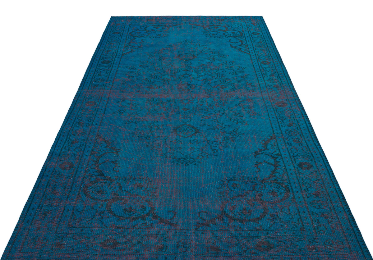 Teal and dark charcoal distressed traditional rug with a central medallion and ornate border pattern.