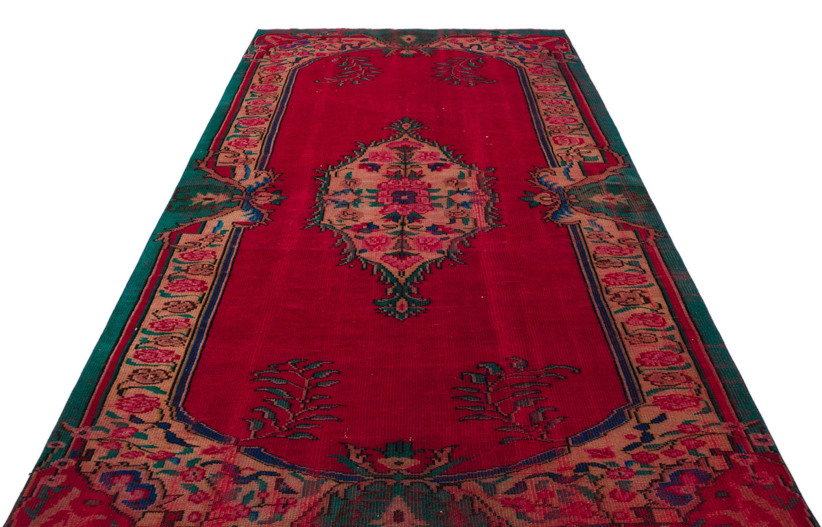 Red traditional rug with a central floral medallion, ornate border, and green and tan accents on a white background.