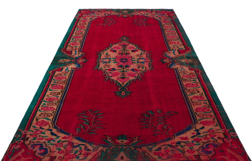 Load image 1 in gallery view. Red traditional rug with a central floral medallion, ornate border, and green and tan accents on a white background.