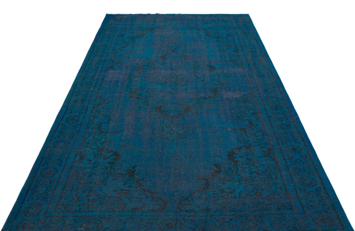 Deep blue rectangular rug with a dark, distressed traditional medallion pattern on a white background.