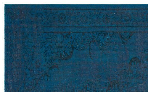 Load image 1 in gallery view. Deep blue rug with a dark, distressed floral medallion pattern and a decorative border.