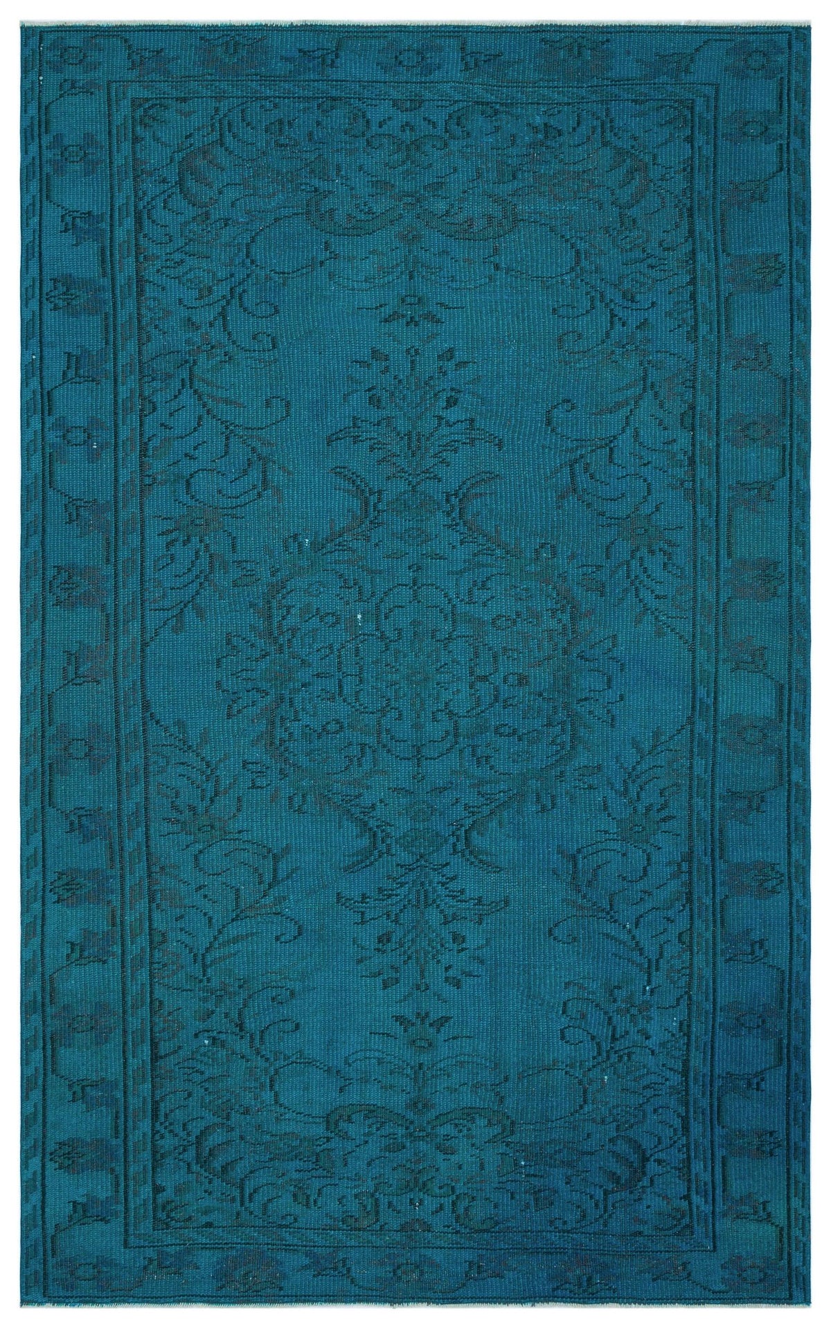 Teal rug with a dark, monochromatic floral medallion pattern and a decorative border.