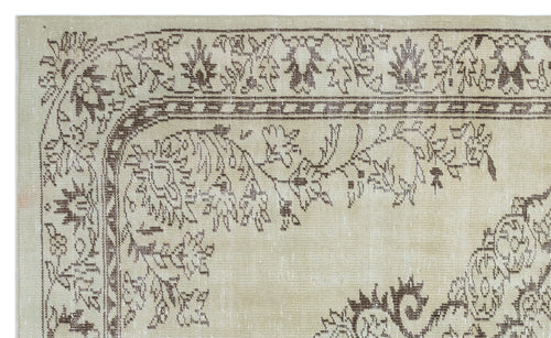 Load image 1 in gallery view. Beige and brown vintage-style rug with a distressed floral border and ornate central medallion pattern.