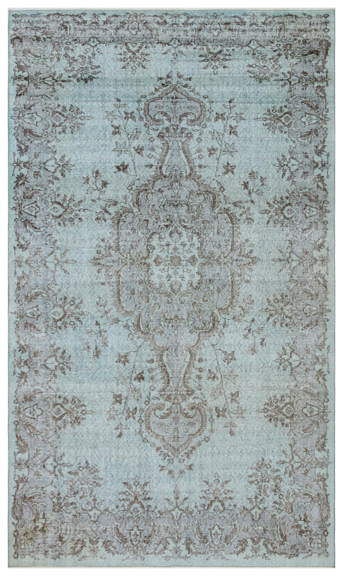 Light blue and brown distressed rug with a traditional central medallion and floral border pattern.