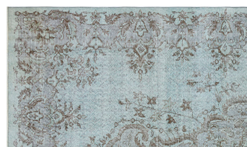 Load image 1 in gallery view. Light blue and brown distressed rug with a traditional floral medallion pattern.