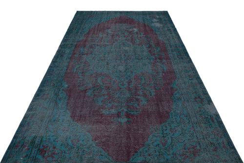Load image 1 in gallery view. Distressed teal and deep plum vintage-style rug with a central floral medallion pattern on a white background.