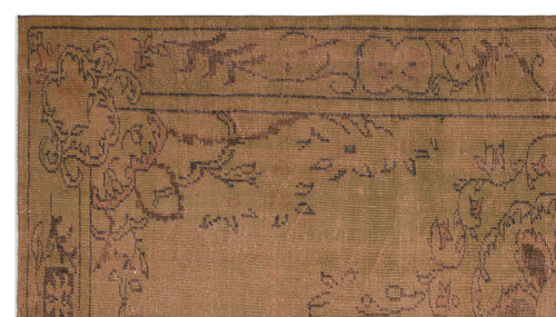 Load image 1 in gallery view. Brown vintage-style rug with a dark charcoal floral border and faded, distressed botanical motifs.