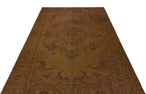 Load image 1 in gallery view. Distressed brown and plum vintage-style rug with a central medallion and ornate border pattern on a white background.