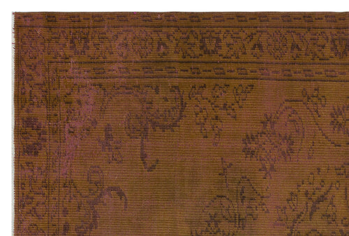 Load image 1 in gallery view. Rust and brown vintage-style rug with a faded floral pattern and a decorative border.