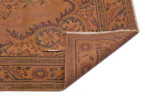 Load image 1 in gallery view. Distressed burnt orange rug with a dark floral medallion pattern and fringed edge, shown on a white background.