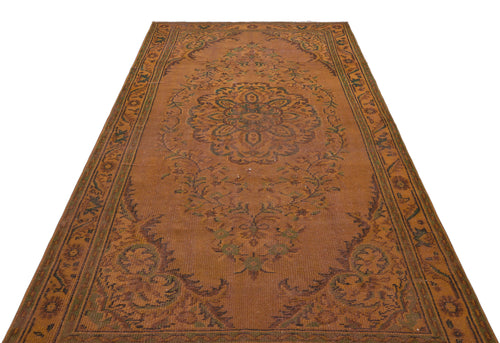 Load image 1 in gallery view. Rust-colored traditional rug with a central floral medallion and intricate border pattern on a white background.