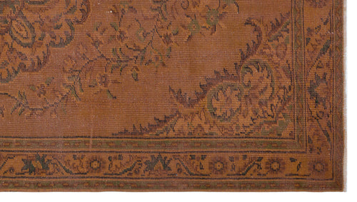 Load image 1 in gallery view. Rust-colored rug with a dark green floral medallion pattern and a geometric border.